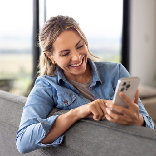 Woman smiling at phone